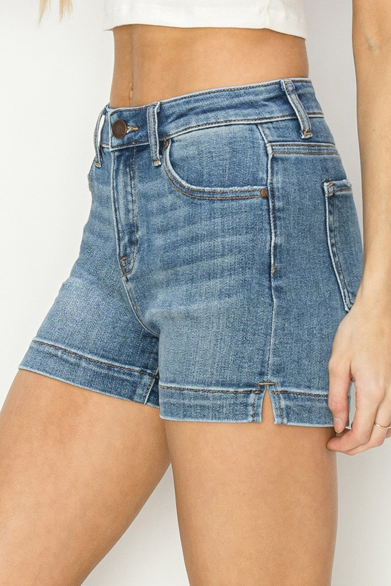 High Rise Side Slit Basic Shorts in blue denim with front button and zipper, pockets, and side slits. Available in sizes XS to XL.