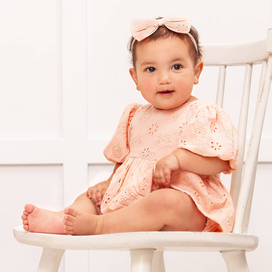 Eleanor Pink Eyelet Skirted Puff Sleeve Bodysuit; cotton, comfy, includes matching headband; sizes 0-6 months.