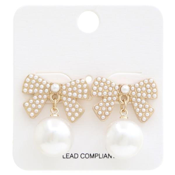 The Rhinestone & Metal Bow Earrings feature gold-tone tops with small pearls and rhinestones, plus a large, round pearl dangling below. Size: One size.