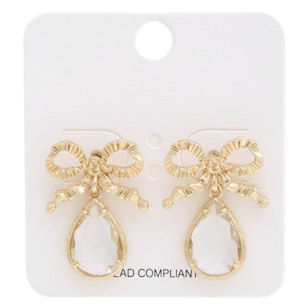 The Rhinestone & Metal Bow Earrings feature detailed rhinestone bow patterns with dangling teardrop-shaped clear faceted stones. Available in one size.
