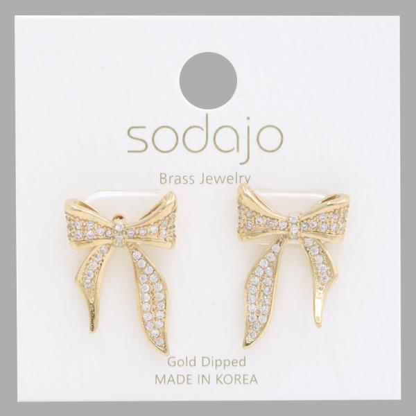Rhinestone & Metal Bow Earrings feature gold-dipped bows with small crystals, crafted in Korea. Available in one size.