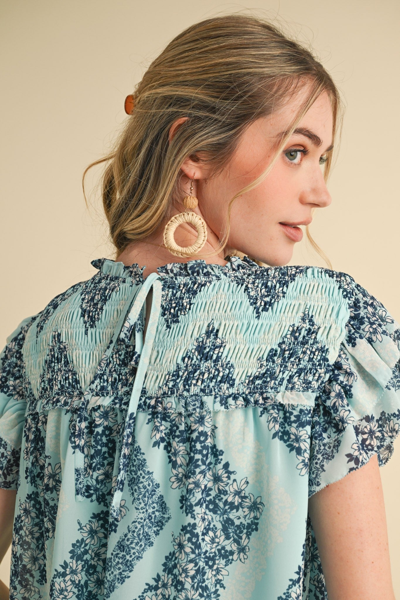 Teal Floral Smocked Yoke Ruffle Trim Top with smocked detailing and ruffle trim. Available in sizes XS-XL.