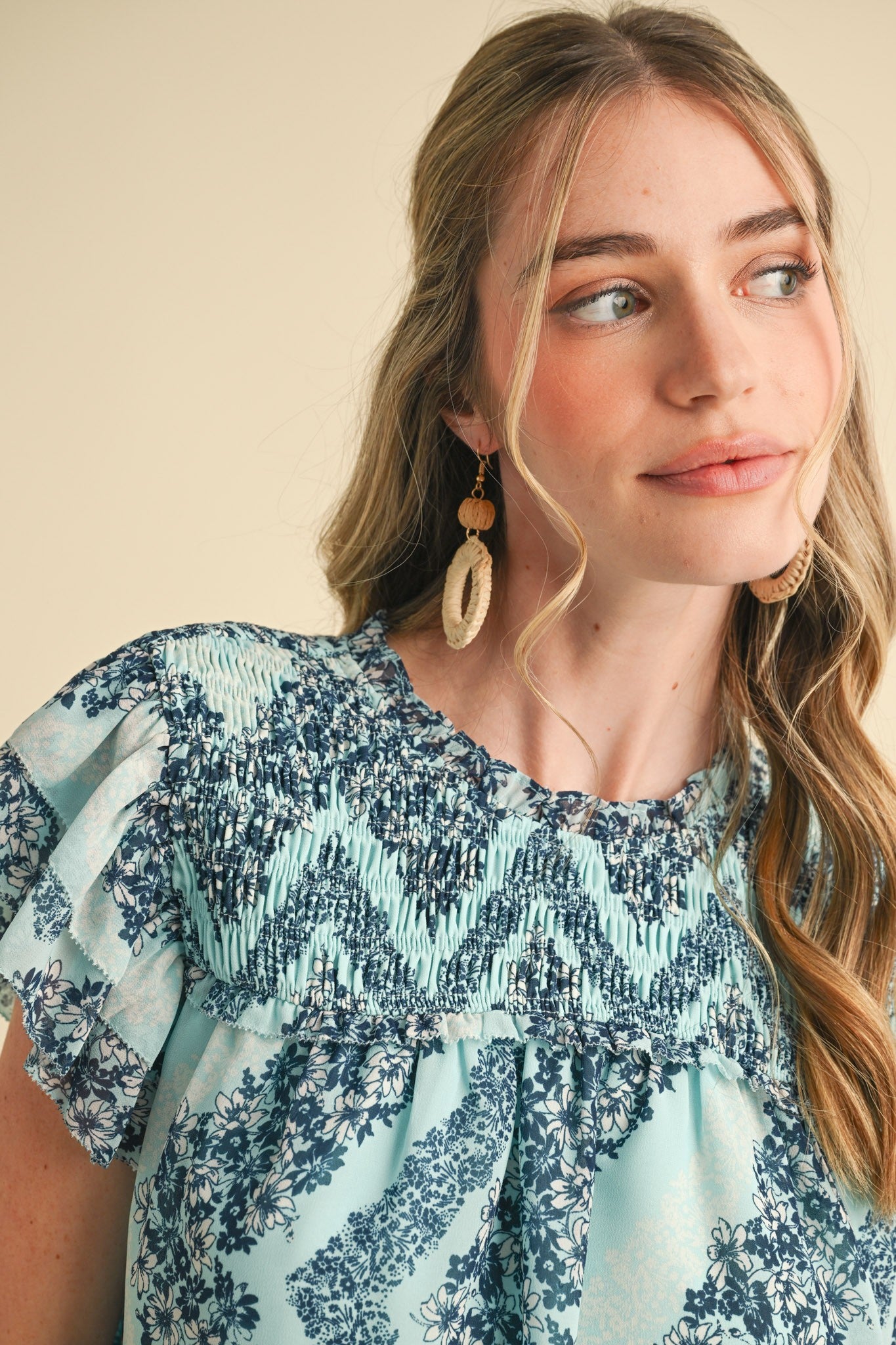 Teal Floral Smocked Yoke Ruffle Trim Top; available in sizes XS-XL. Features smocking and ruffled sleeve trim.