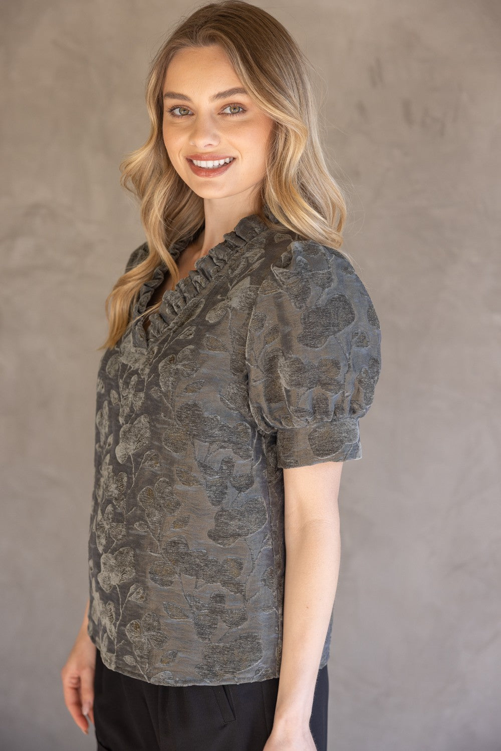 Charcoal Ruffled V-Neck Textured Velvet Top; features ruffle detail; available in sizes XS-XL.
