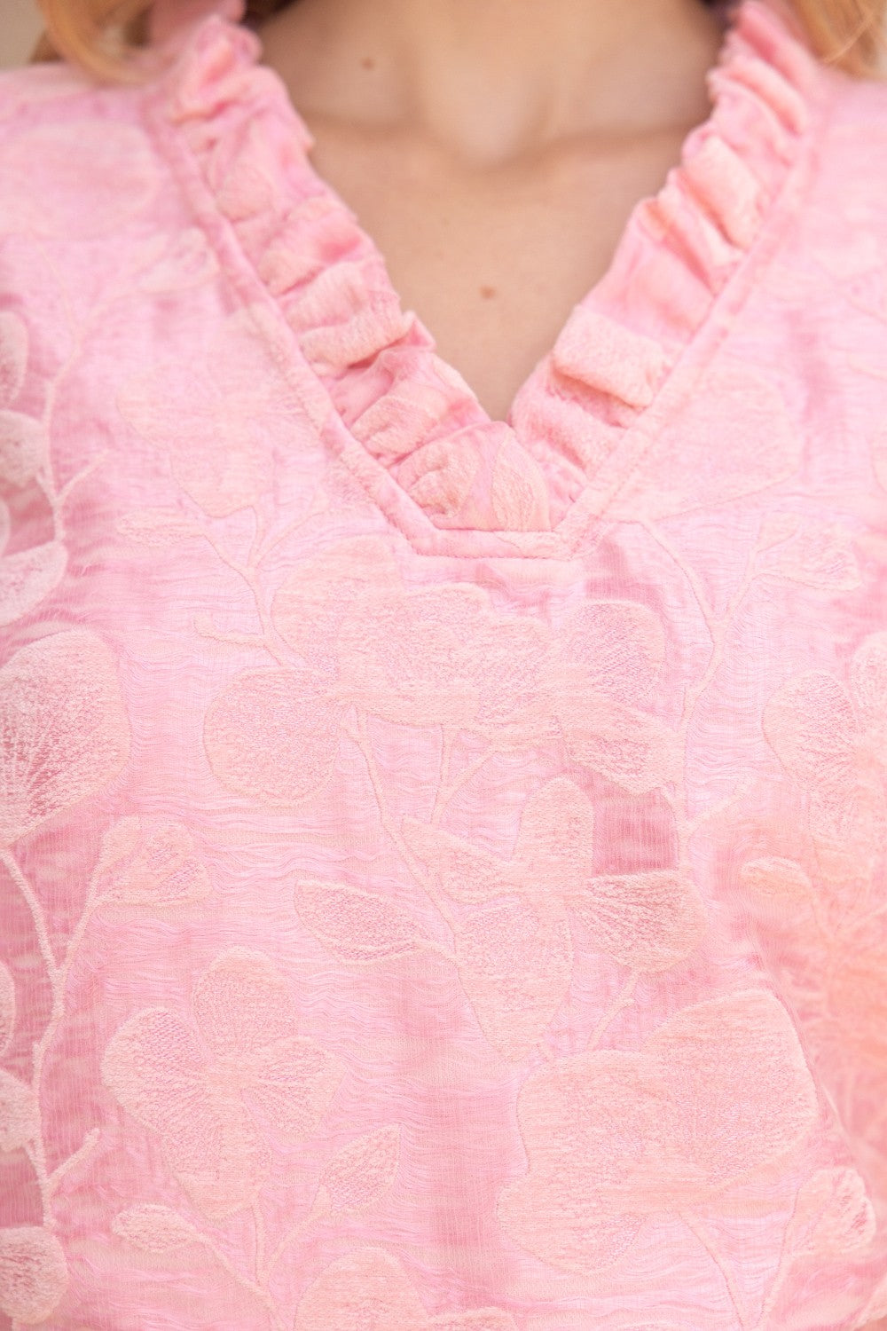 Poppy Ruffled V-Neck Floral Top in light pink with textured fabric, ruffled collar, V-neckline. Available in XS-XL.
