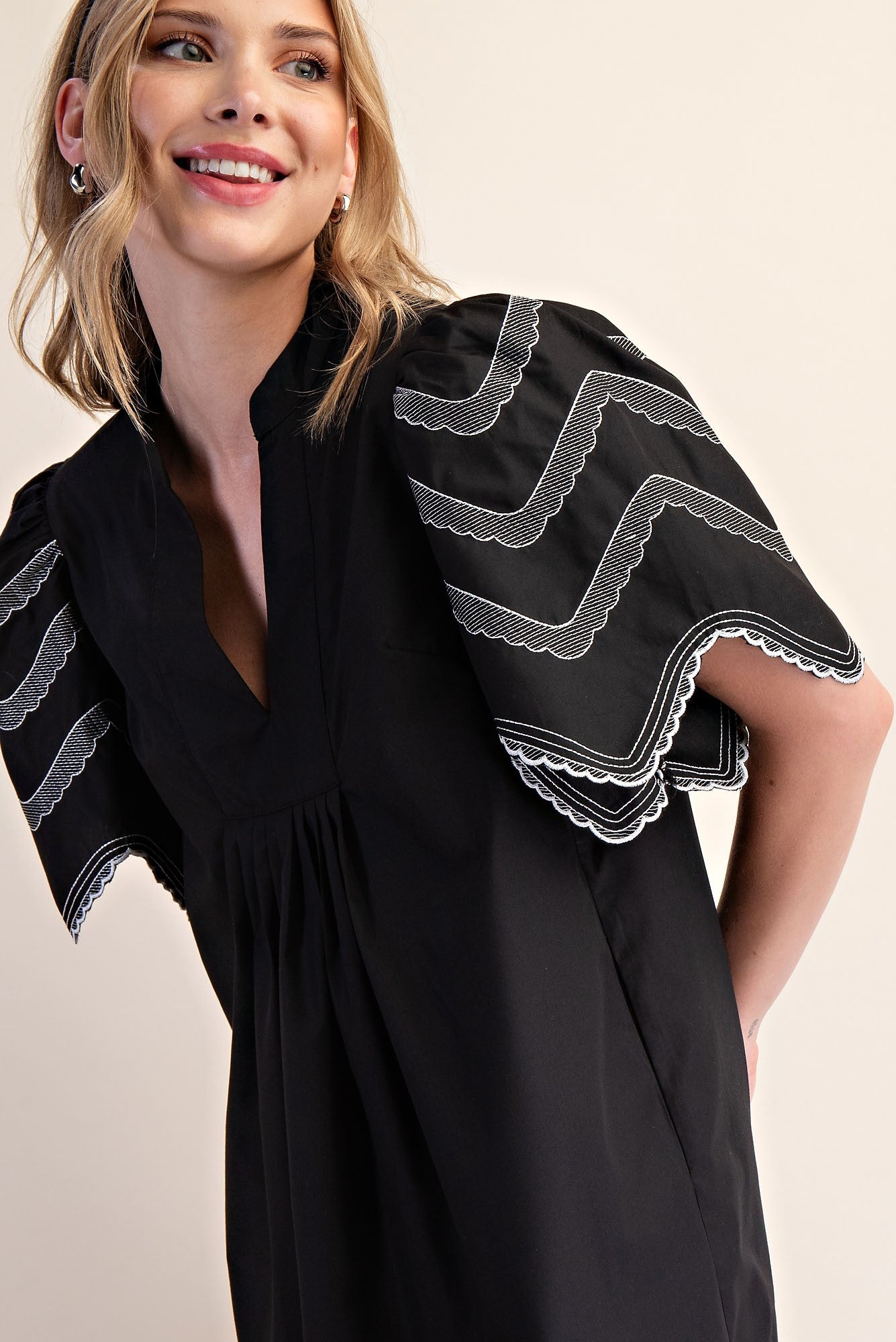 Heidi Balloon Sleeve Dress: black, wide short sleeves, white scalloped zigzag embroidery. Available in sizes XS–XL.
