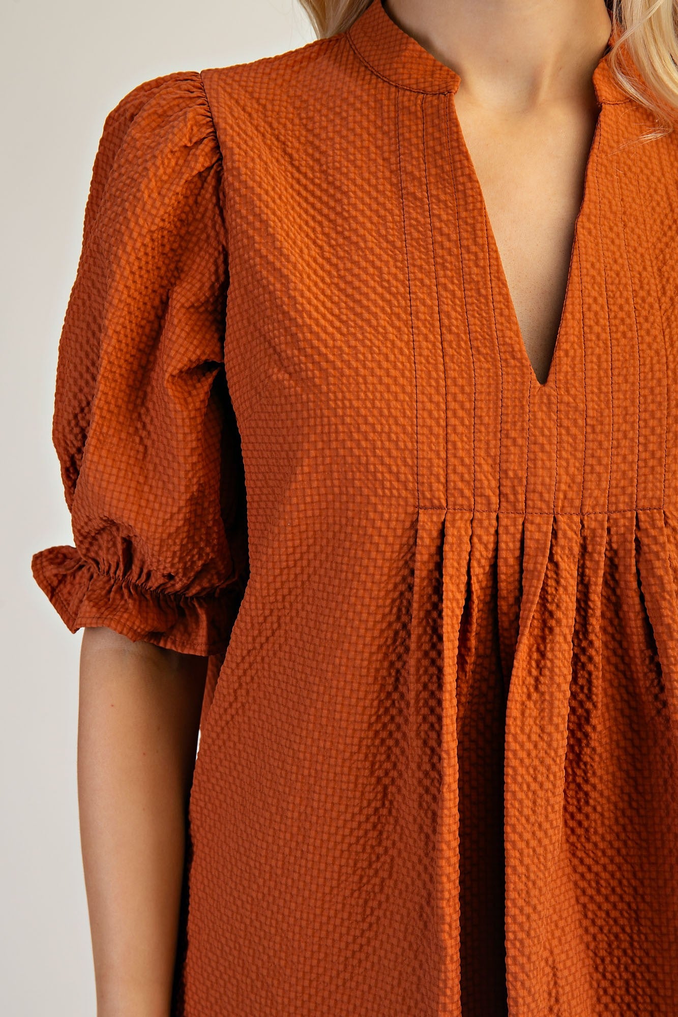 Rust-colored Lyla Puff Sleeve Dress with v-neck, short puff sleeves, pleated under bust. Available in sizes XS-XL.