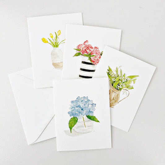 Set of 8 unique watercolor flower notecards with matching white envelopes. Each card features a distinct floral vase design. Size: A2.