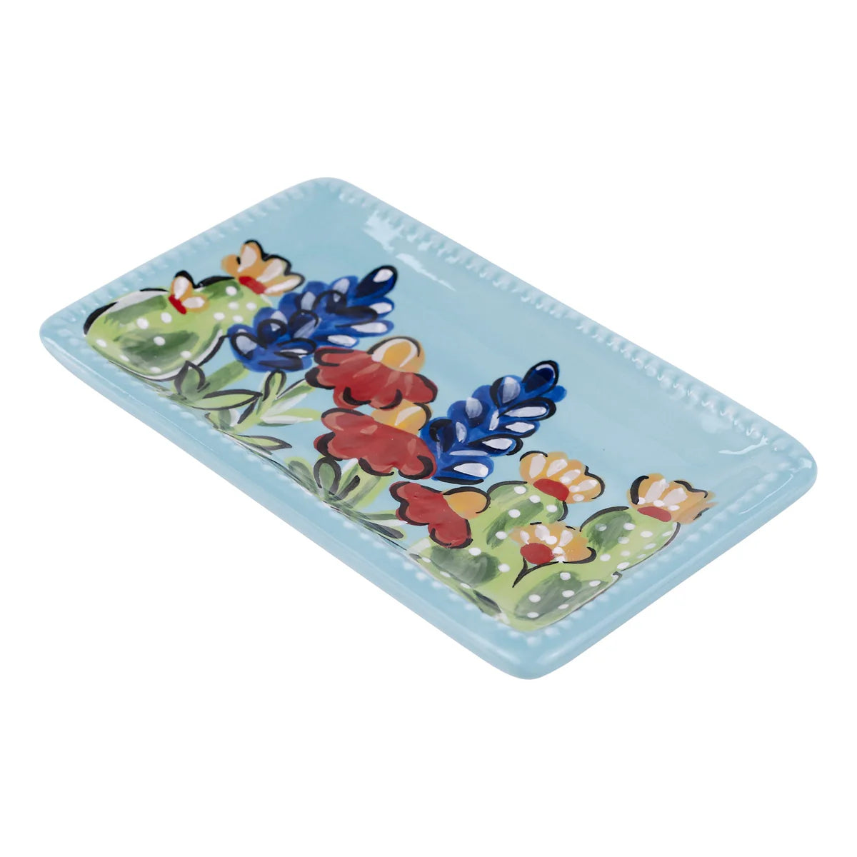 Texas Wildflower Trinket Tray: Rectangular ceramic tray with light blue background. Features hand-painted red, blue, and yellow flowers alongside cactus designs. Available size: 8" x 5". Decorative and functional for serving or display.
