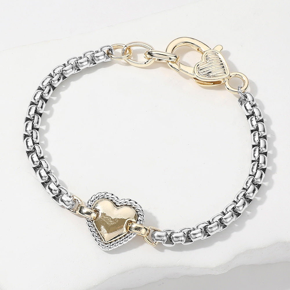14K gold-plated two-tone bracelet with silver chain, gold heart charm, and heart toggle clasp. Sizes: S, M, L.