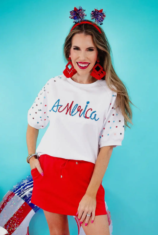 Dreaming in The Stars Tinsel Top with star accents; available in sizes XS–XL.