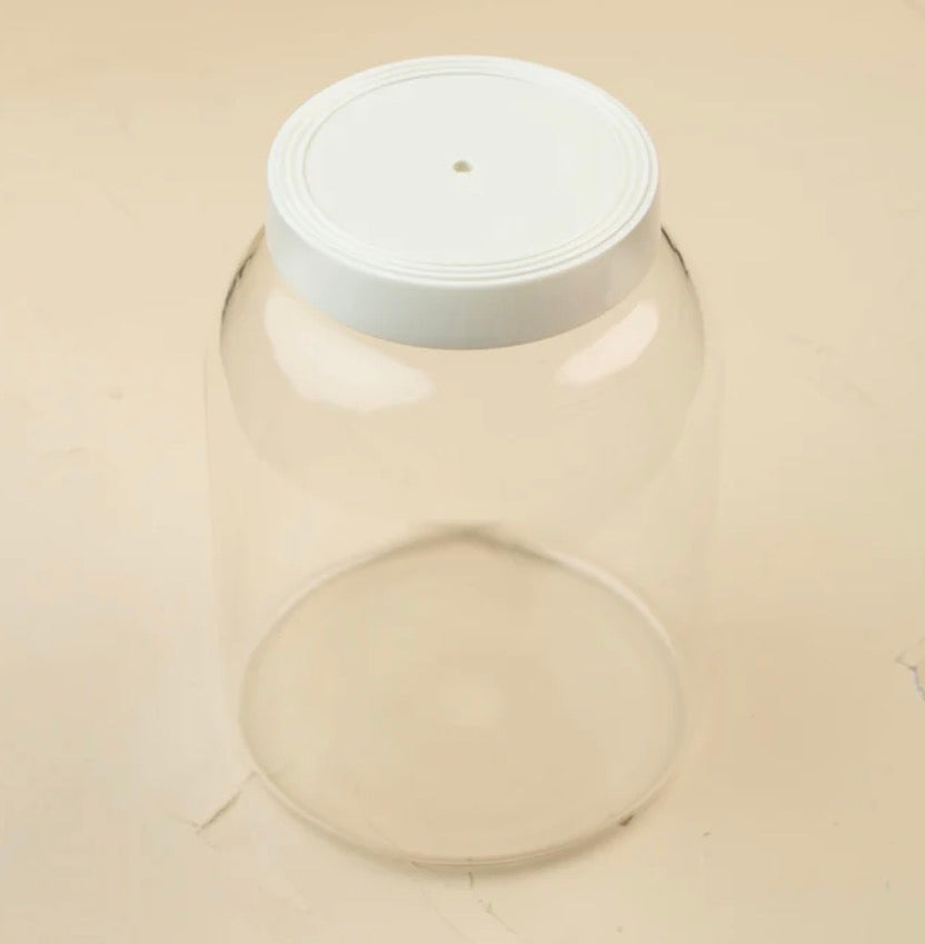 Large clear customizable kitchen canister with white screw-on lid featuring a small center hole; available in multiple sizes.