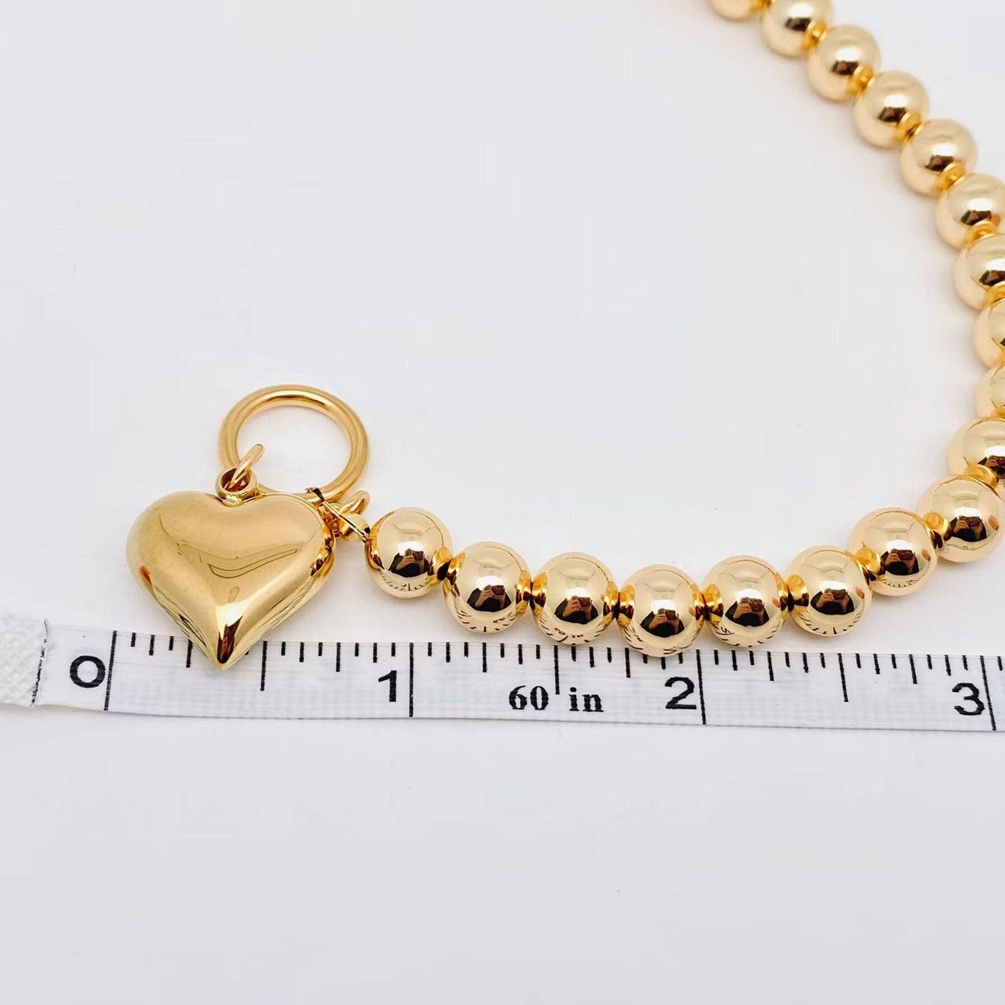 18K gold-plated heart charm bracelet with 8mm beads, approx. 16-inch length. Available in 8mm bead size and 16-inch length.