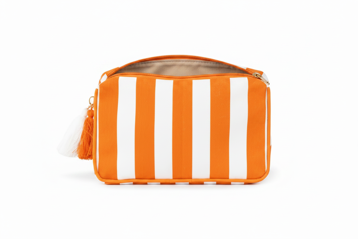 Burnt orange and white striped laminated canvas cosmetic bag with a white tassel zipper. Sizes available.