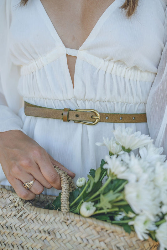 Everyday Skinny Brass Buckle Leather Belt: A sleek leather belt with a brass buckle, ideal for accentuating any outfit. Sizes available: XS, S, M, L, XL.