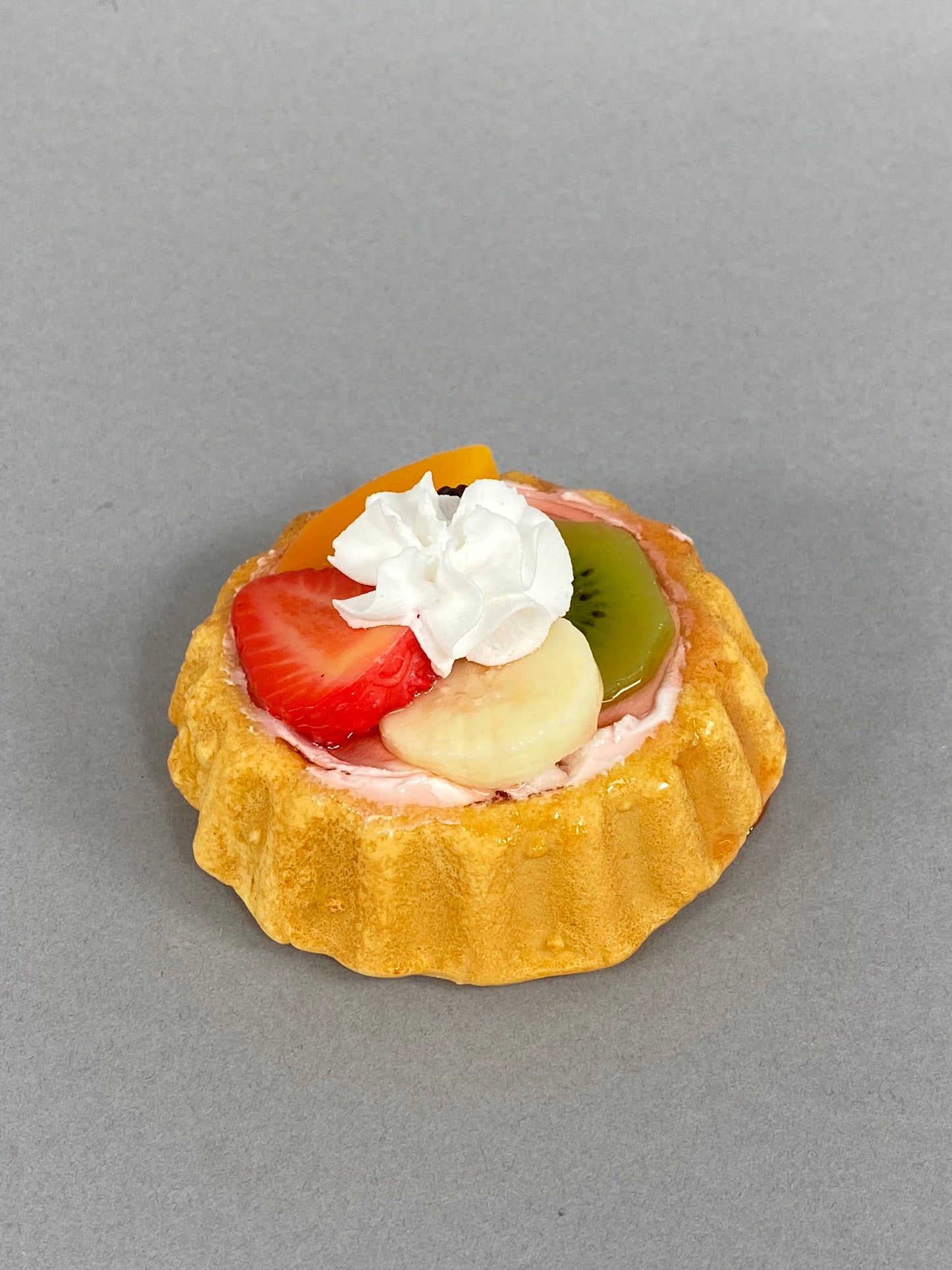 Small Fake Assorted Fruit Tart with golden crust, faux fruit, glossy glaze, and whipped cream. Size: small.
