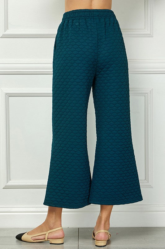 Teal quilted wide-leg pants with elastic waistband. Available in sizes XS-XL.