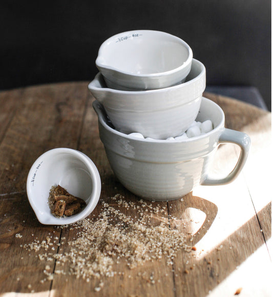 Set of three white Batter Bowl Measuring Cups, stackable, available in small, medium, and large sizes.