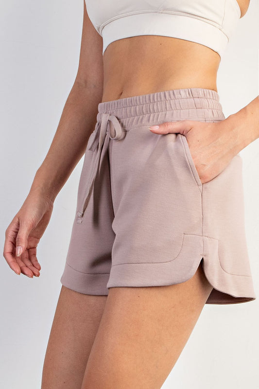 Modal Scuba Tulip Short: light mauve, elastic waist, side slits, pockets. Available in XS–XL.