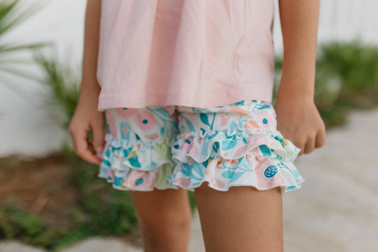 Girls Pastel Floral Ruffle Short Set: pink shorts, colorful floral ruffle sleeves. Available in sizes 2T–10.
