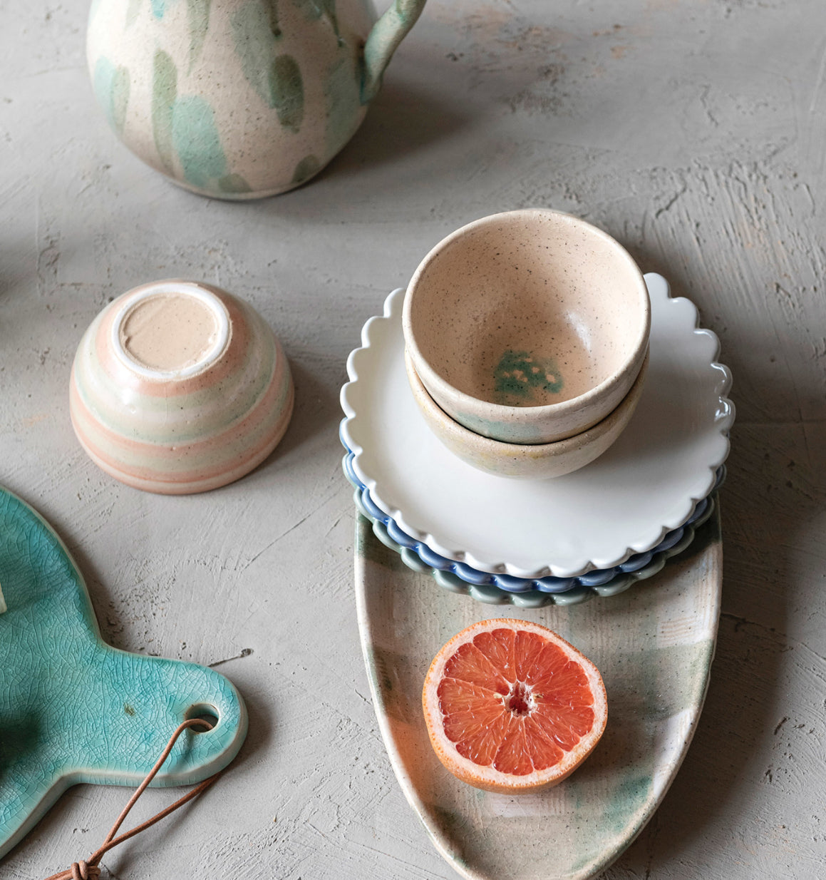 blue and white checkered towel. The 8" Round Stoneware Plate With Scalloped Edge is available in both regular and large sizes.