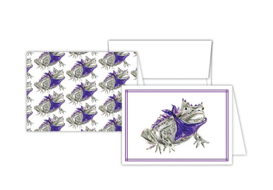 Petite Notes Handpainted set includes two greeting cards with a detailed illustration of a frog in a purple bandana. One card features the frog image framed, and the other displays it in a repeated pattern. Perfect for snail mail enthusiasts. Sizes available: Not specified.