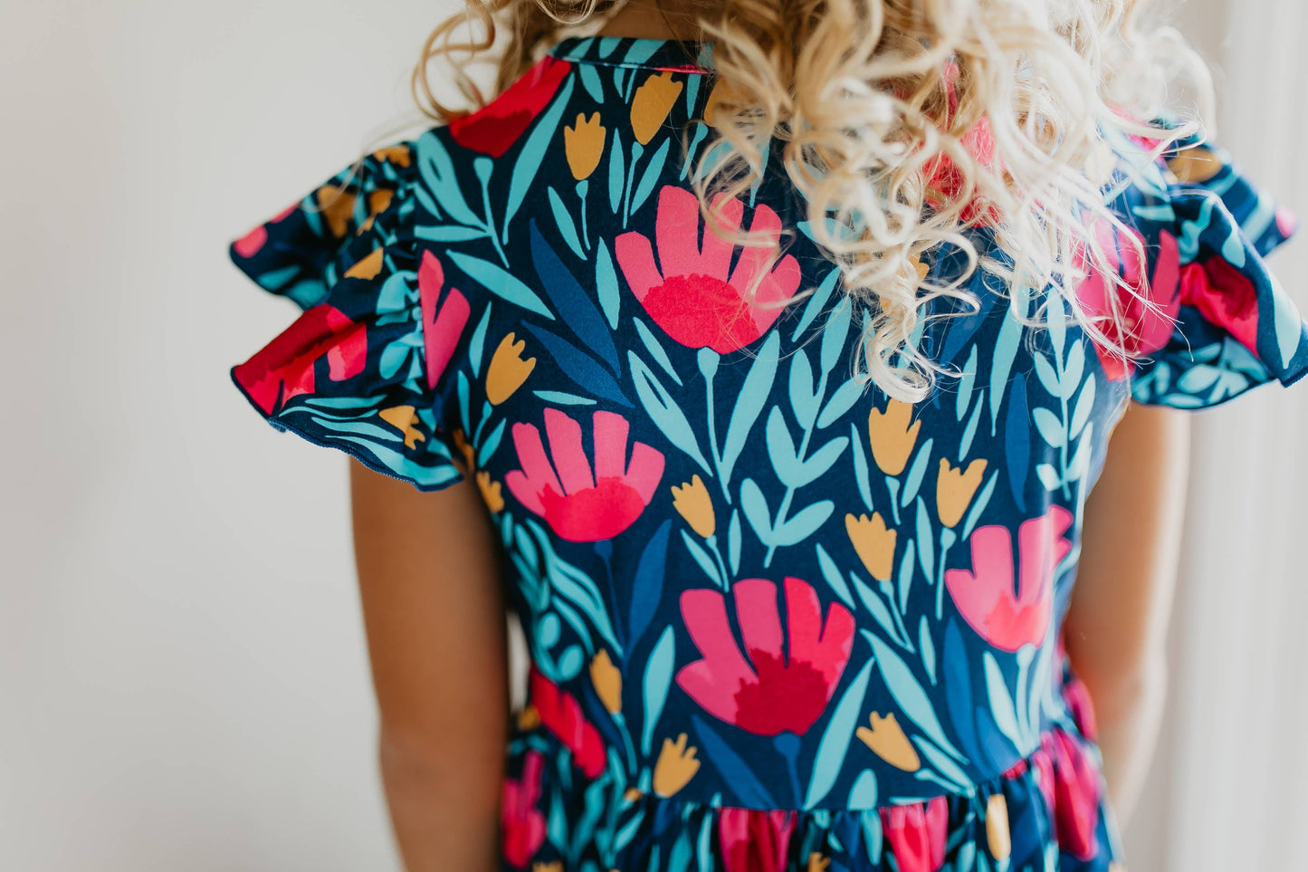 Kids Blue Floral Flutter Sleeve Dress with colorful floral pattern. Available in sizes 2T-6X.