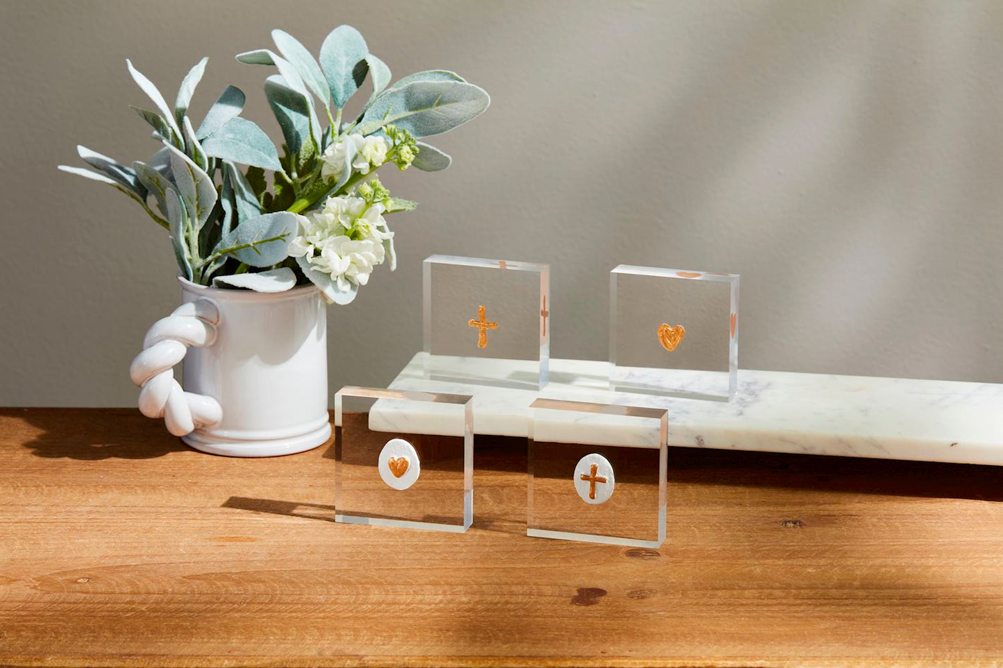 Mini Acrylic Icon Plaques with gold hearts and crosses, set on a white marble slab. Available sizes: Small.