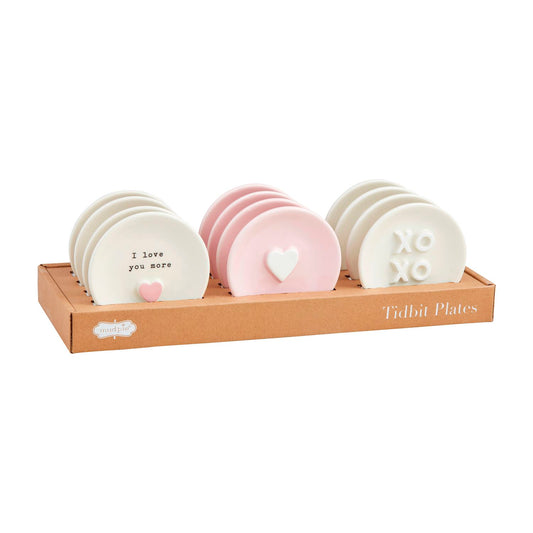 The Mom Tidbit Plates set includes eight pink and white plates with raised heart designs and phrases like "I love you more" and "XOXO.