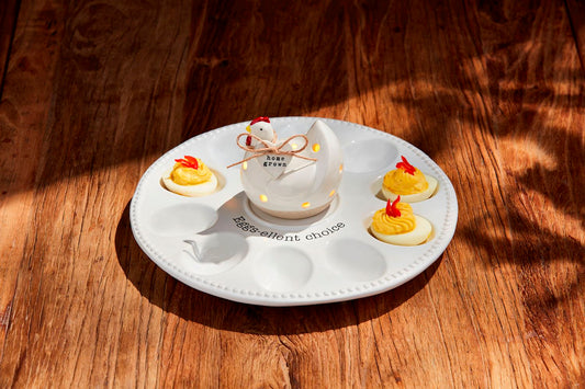 The Deviled Egg Tray Light-Up Holder stylishly holds four stuffed eggs. It features a hen-shaped salt shaker labeled "home grown" in the center.