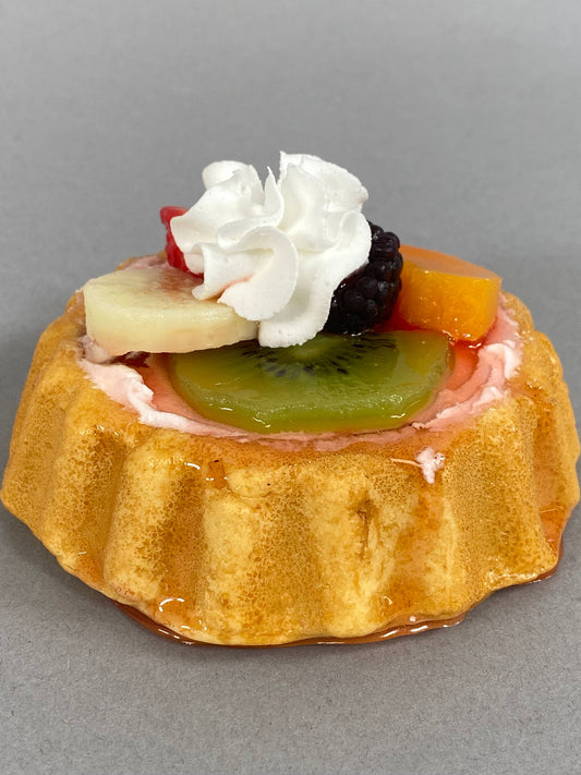 Small fake assorted fruit tart with sponge cake, kiwi, banana, peach, blackberry, whipped cream. Available in small size.