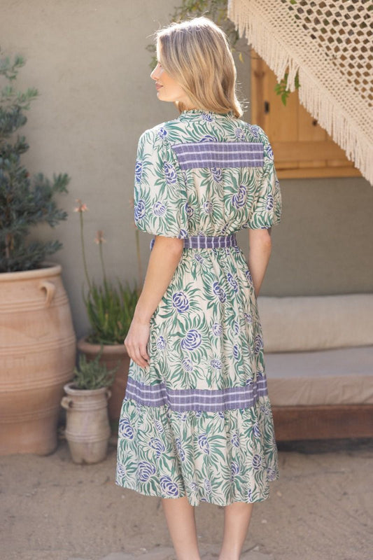 Sadie Dress with green leaves, blue flowers, purple stripes, and bubble sleeves. Available in sizes XS-XL.