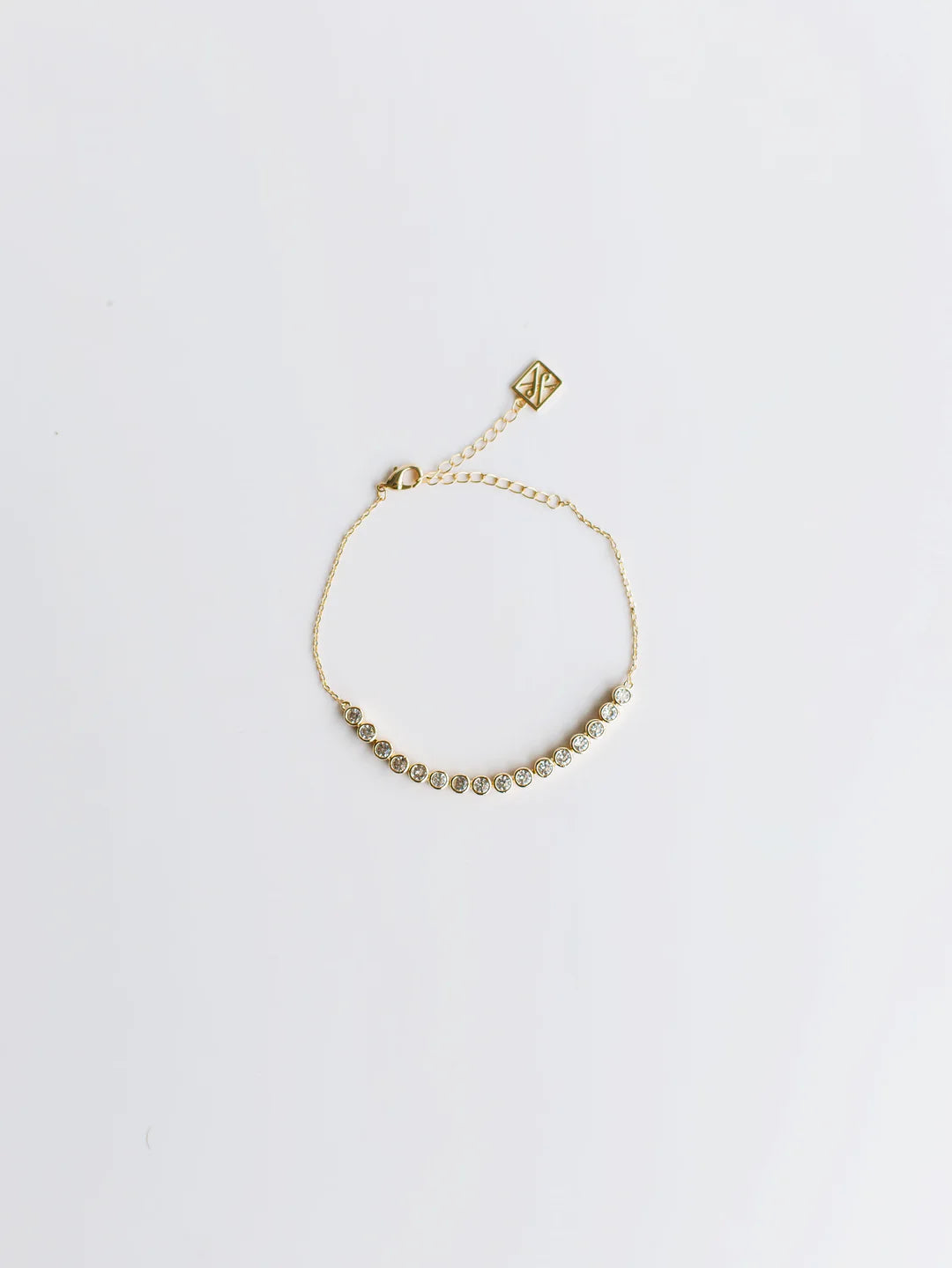 The Tieghan Bracelet has a delicate gold chain, round glass stone accents, and adjustable clasp. Available in S/M and M/L sizes.