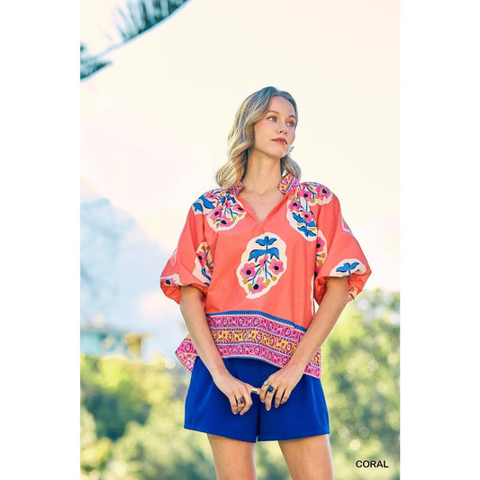 Sunset Floral Embroidery Top features colorful floral patterns. Available in sizes XS-XL.