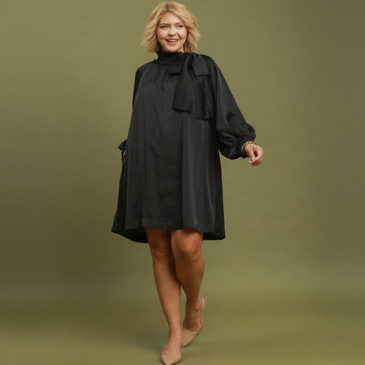 Black Satin Tie Neck Dress with long sleeves, loose fit, satin finish. Available in plus sizes.
