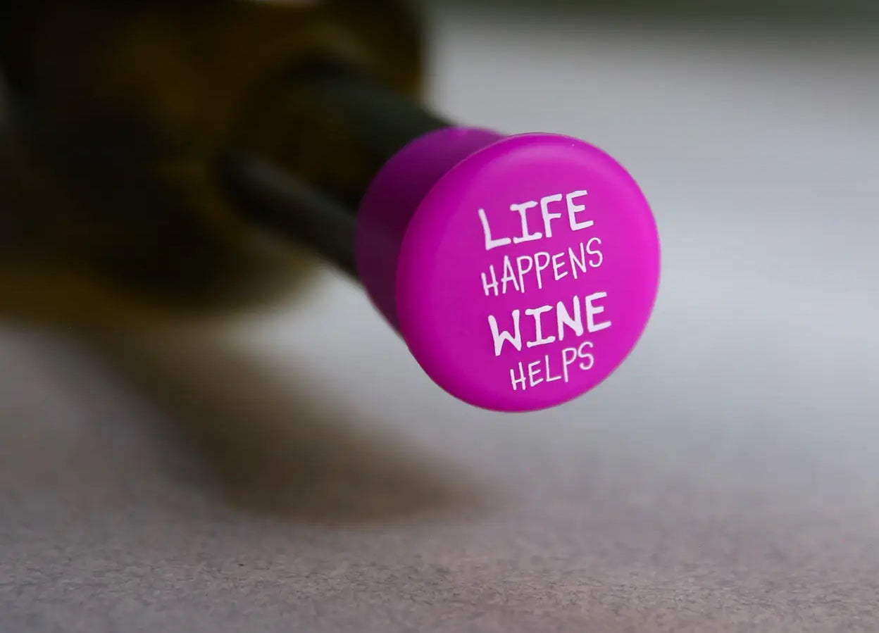 Wine Cap sealing a bottle, with “LIFE HAPPENS WINE HELPS” in white. Available in standard and large sizes.
