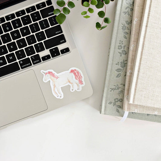 Laptop with Unicorn sticker near touchpad. Available sizes: 13", 15", and 17".