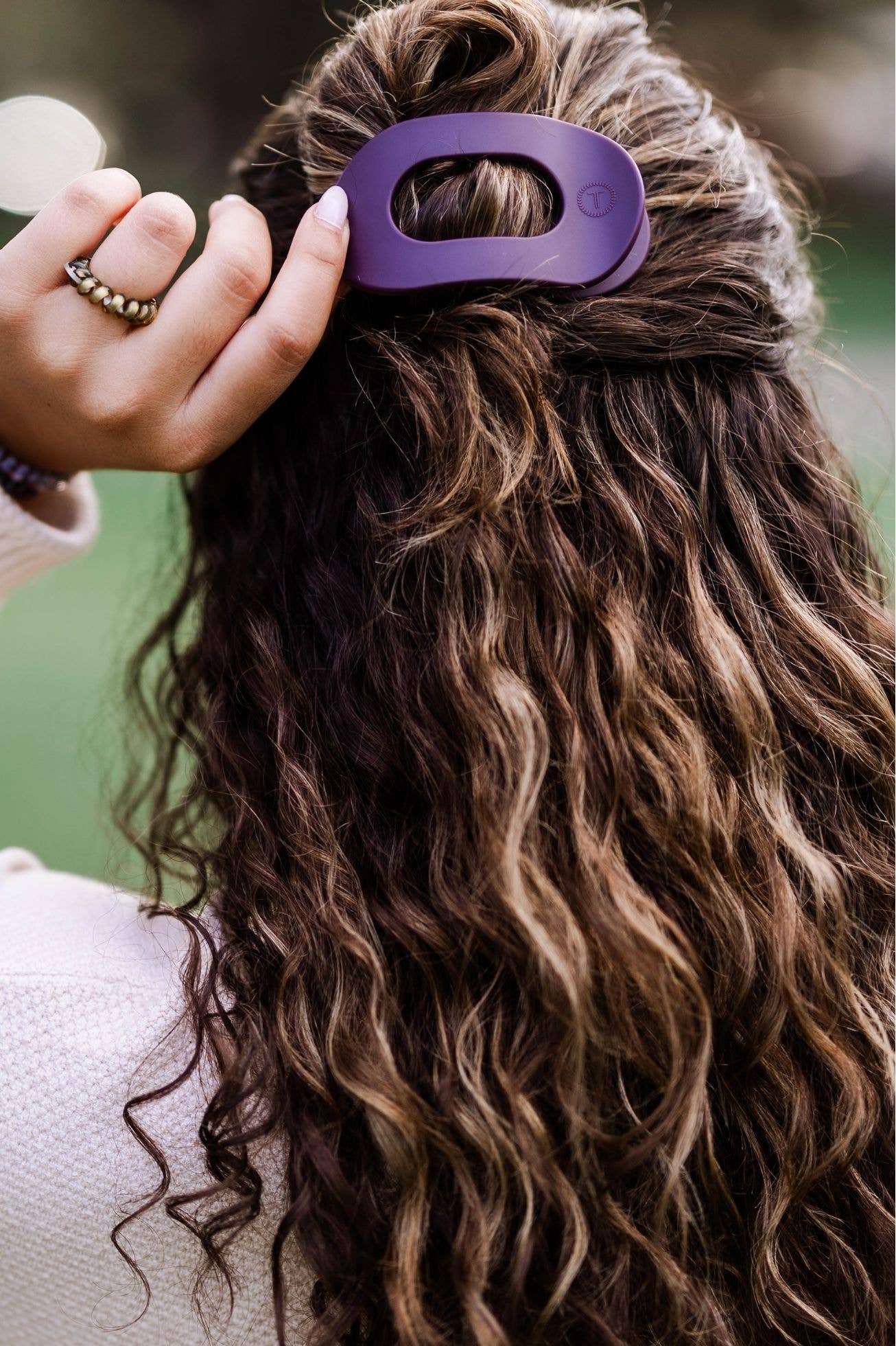 TELETIES Flat Round Hair Clip in use; available in small, medium, and large sizes.