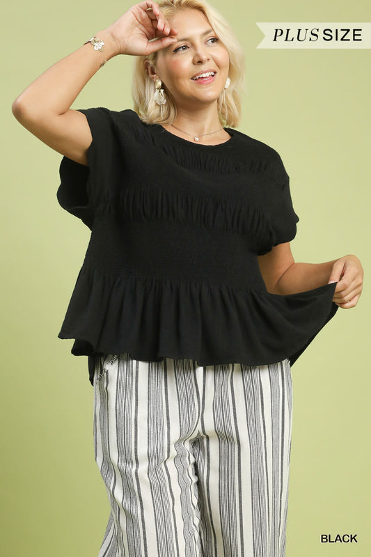 Amelia Smocked Peplum Top in black with scallop-edged sleeves. Available in sizes XS–XL.