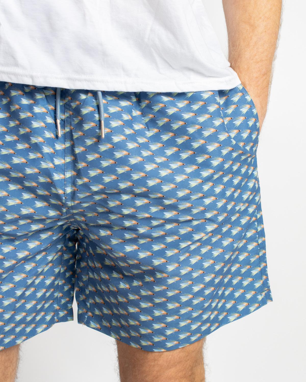 Men’s On The Fly Swim Trunks: blue, geometric print, quick-dry, drawstring waist. Sizes: S–XXL.