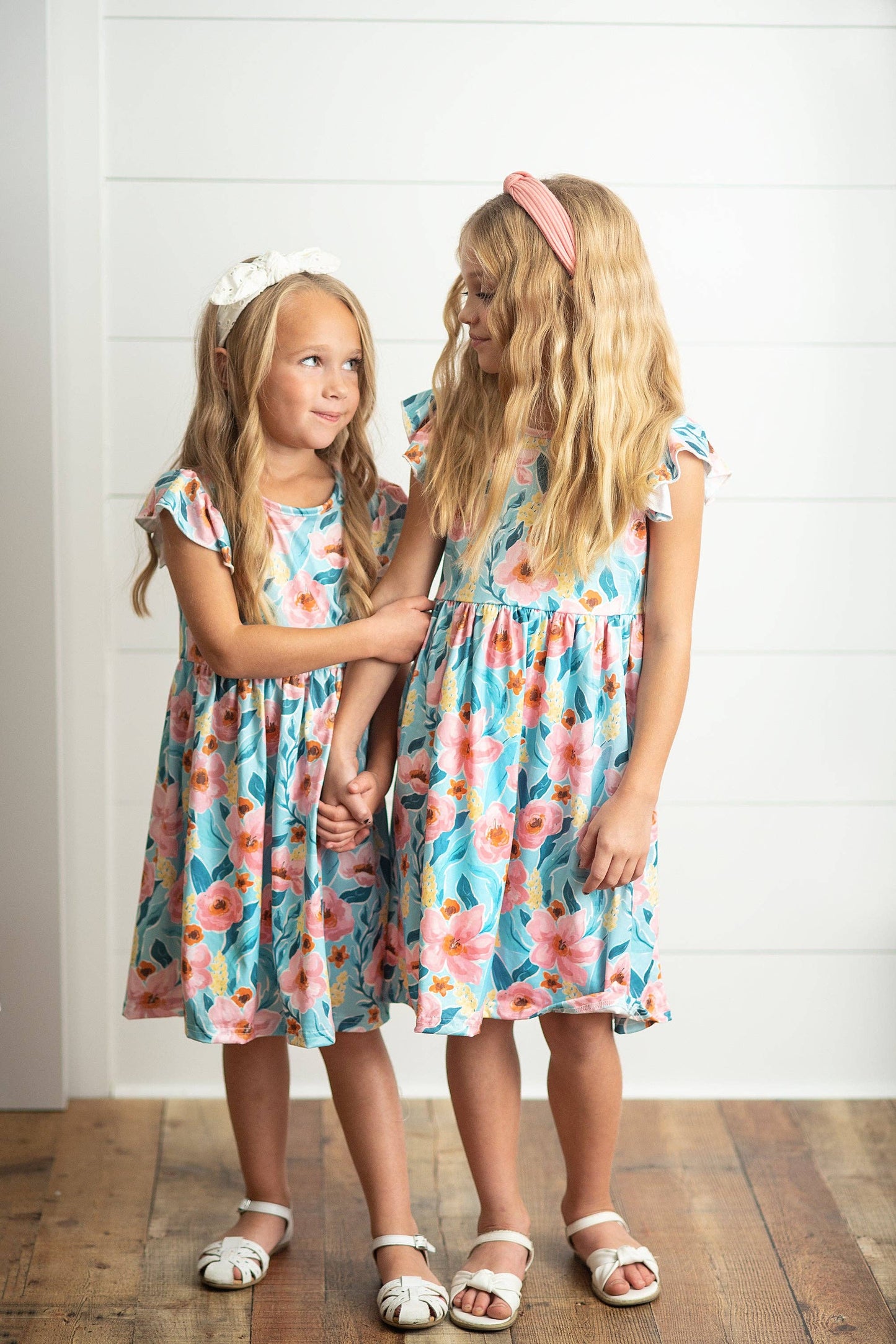 Girls Claire Pink Floral Print Twirl Dress available in sizes 2T-10, features pink floral print and twirly skirt.