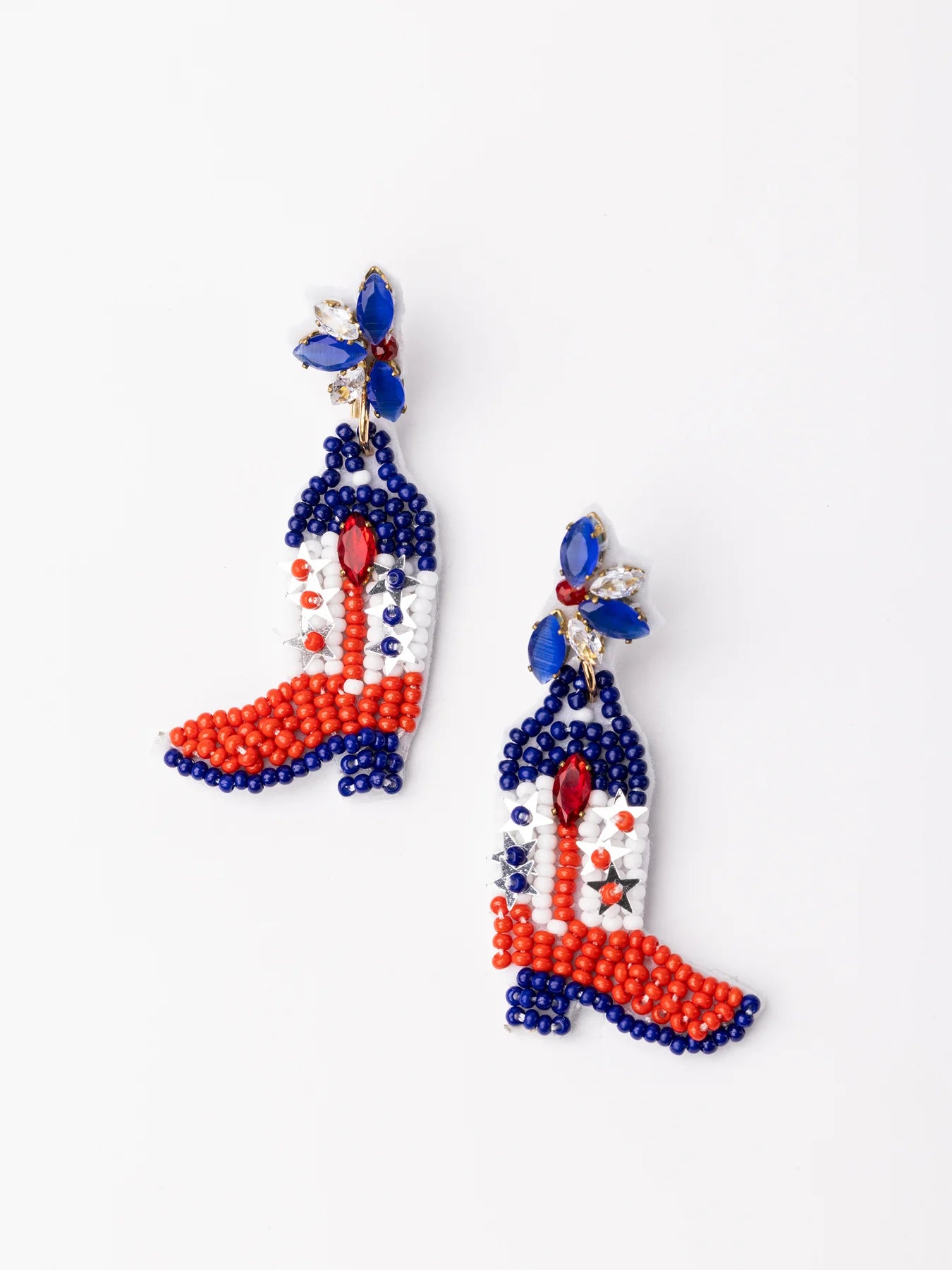 Cowgirl boot-shaped earrings with red, white, and blue seed beads, star accents, and a blue jeweled flower. Sizes: one size.
