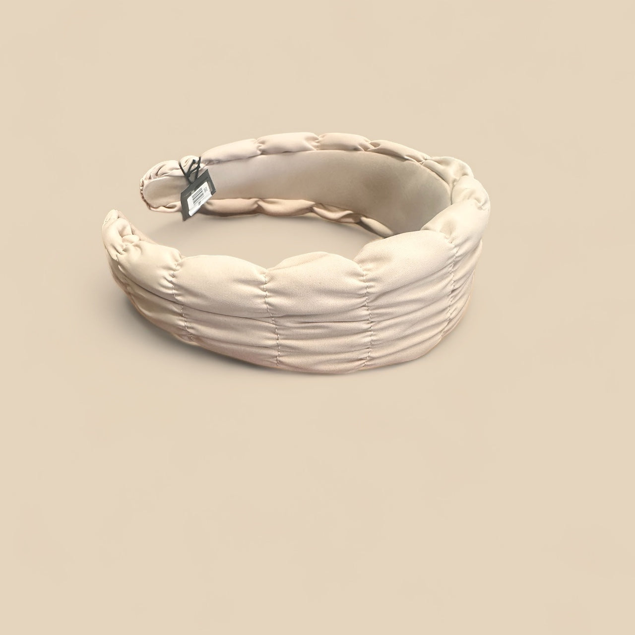 The Spring Headbands feature cream padded ruching and a small black tag. Available in sizes S, M, and L.