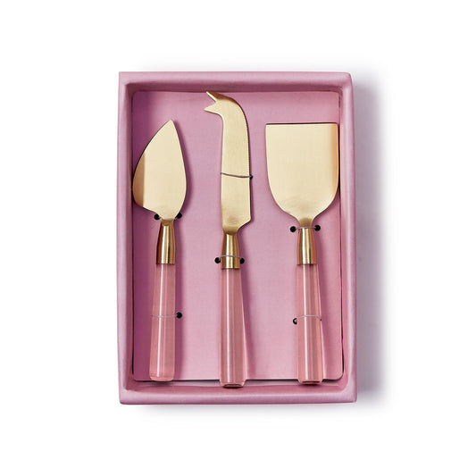 The Pink Blush Set of 3 Cheese Knives features gold stainless steel blades and pink transparent acrylic handles, arranged in a matching pink gift box. Available as a set of 3 knives.