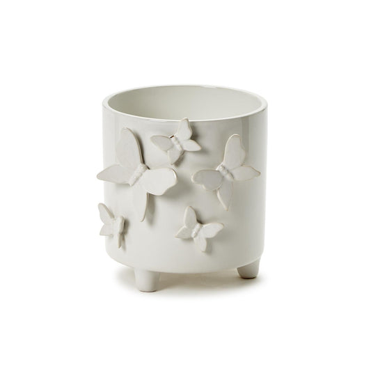 White ceramic cachepot on three short legs with raised butterfly accents. Available in multiple sizes.