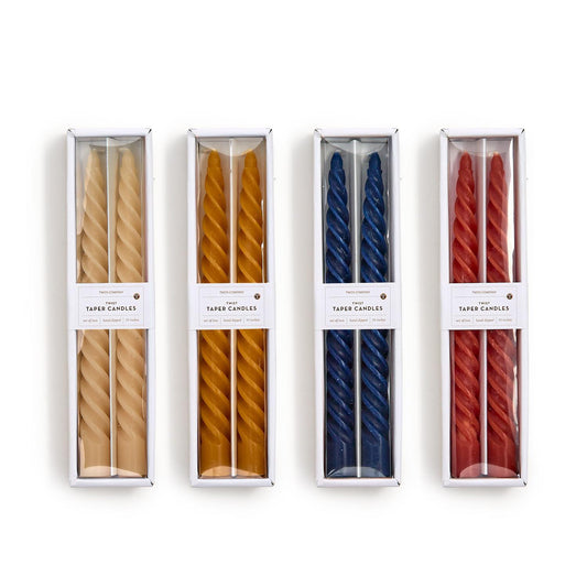 Set of eight Fall Twist Taper Candles in cream, yellow, blue, and red; comes in clear boxes. Sizes: 10" each.