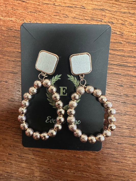 Square silver-toned stud earrings with circular metallic beaded hoops. Available sizes: small, medium, large.