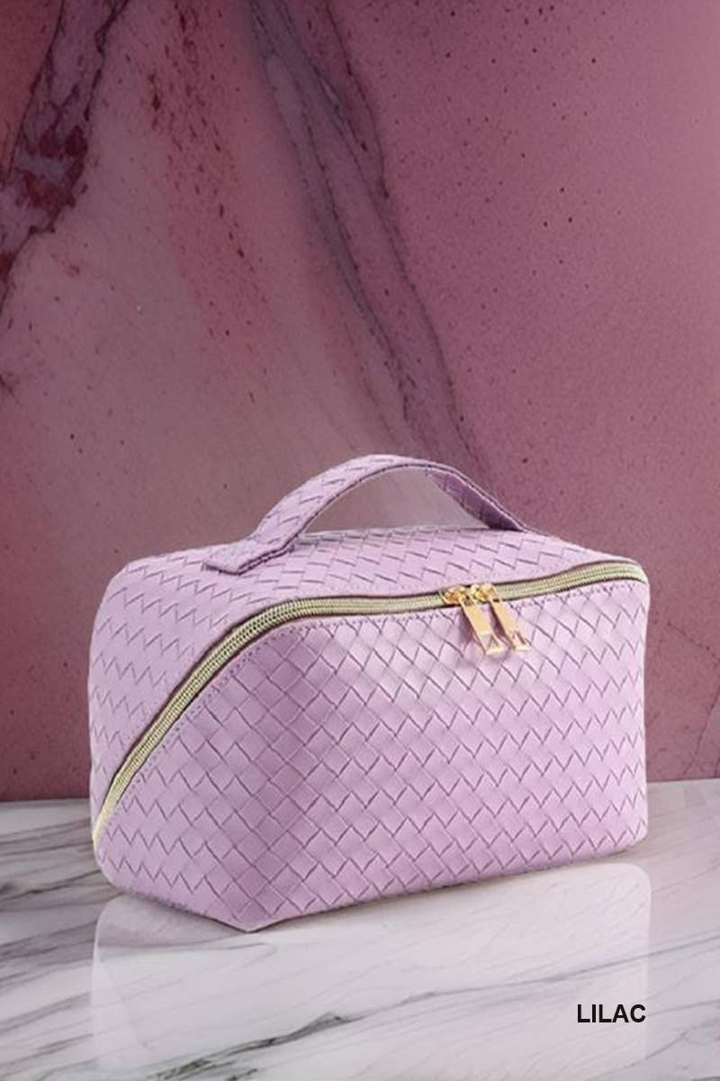 Ivory woven vegan leather makeup bag with gold zipper and handle. Sizes: Small, Medium, Large. "IVORY" in corner.