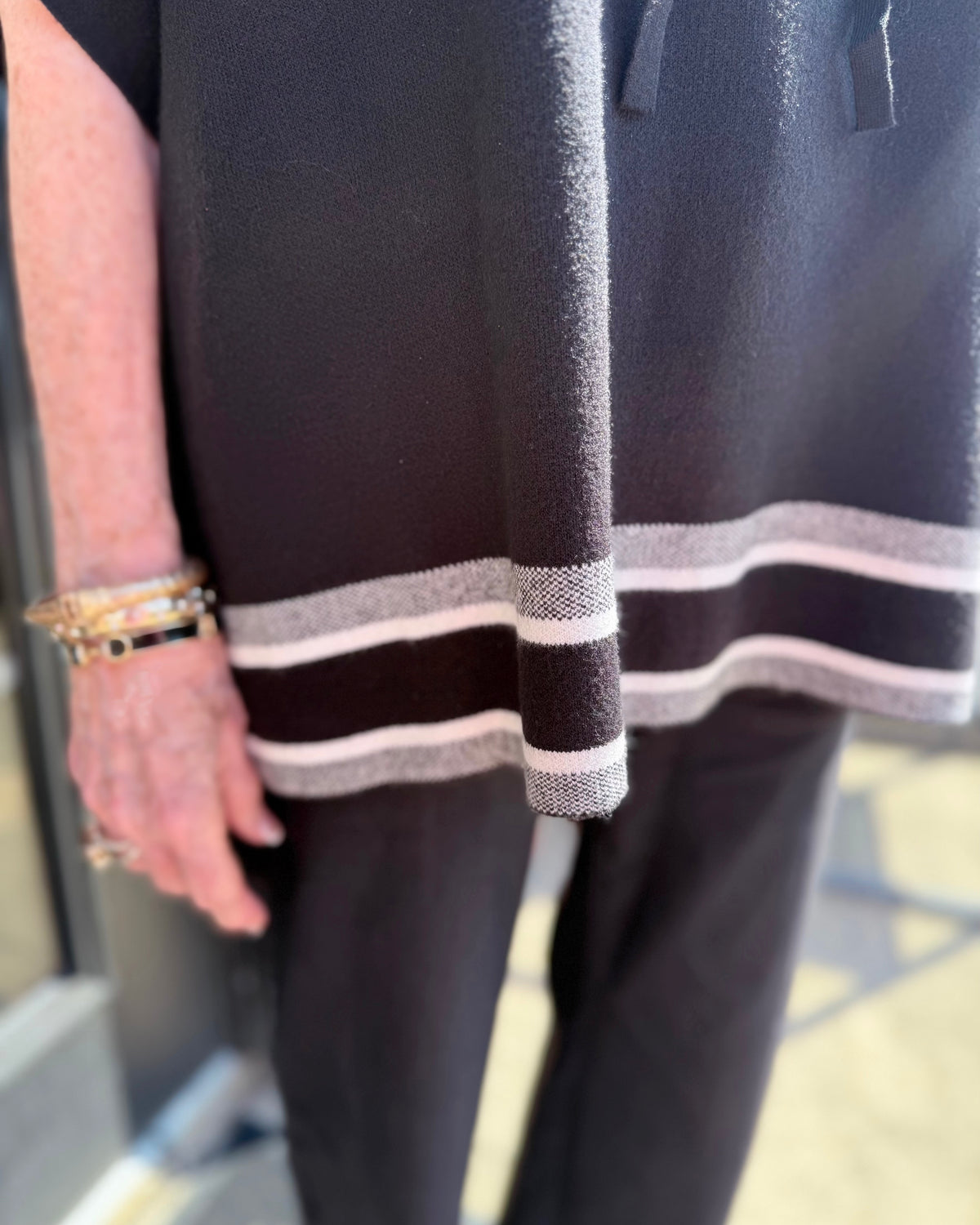 Aspen Stripe Hoodie Poncho with white stripes at the hem, available in sizes S-XL.