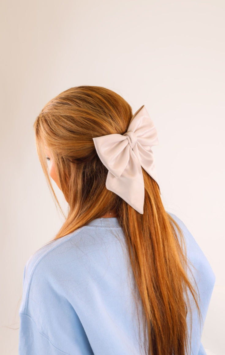 Large, light-colored bow hair accessory; sizes available: small, medium, large.